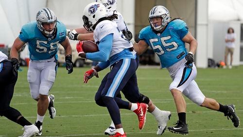 Carolina Panthers middle linebacker Luke Kuechly (59) and linebacker David Mayo (55) close in on Tennessee Titans running back Derrick Henry, center, during a combined NFL football training camp Thursday, Aug. 17, 2017, in Nashville, Tenn. (AP Photo/Mark Humphrey)