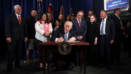 President Donald Trump signs an Executive Order on “Improving Accountability and Whistleblower Protection” at the Department of Veterans Affairs, Thursday, April 27, 2017, in Washington. (AP Photo/Andrew Harnik)