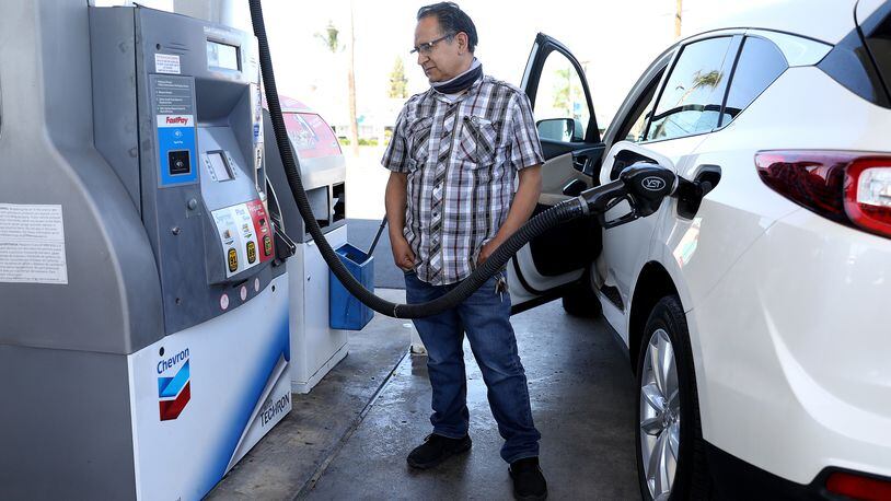 Juan Galaiviz of Santa Ana, California, pumps gas into his automobile at a Chevron gas station on March 8, 2022. Galaiviz paid $50.00 for 8.866 gallons of regular gasoline. (Gary Coronado/Los Angeles Times/TNS)