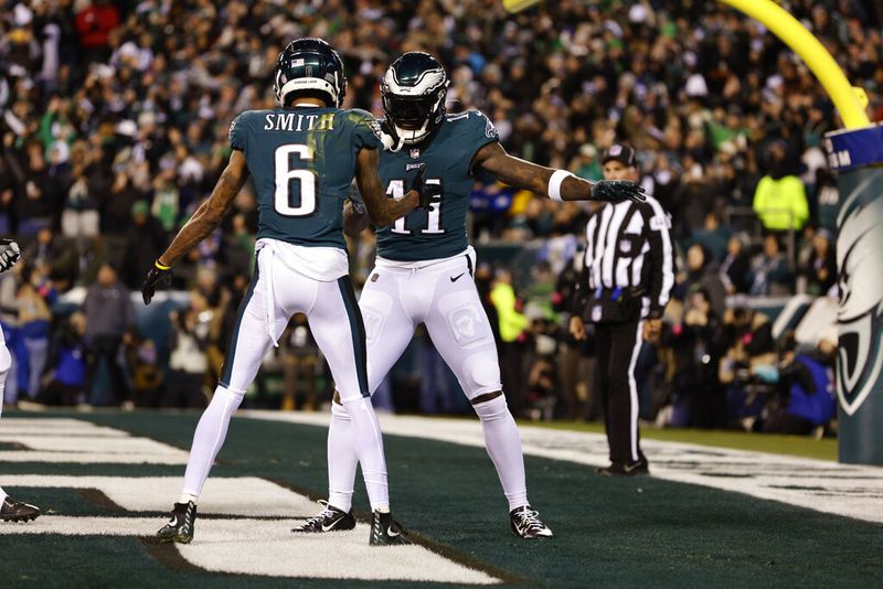 Philadelphia Eagles wide receiver DeVonta Smith (6) celebrates with A.J. Brown (11) after scoring a touchdown during the first half of an NFL divisional round playoff football game against the New York Giants, Saturday, Jan. 21, 2023, in Philadelphia. The Eagles defeated the Giants 38-7.(AP Photo/Rich Schultz)