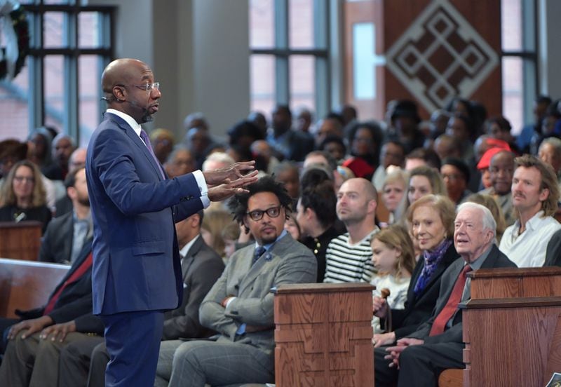 The Rev. Raphael Warnock, pastor of Ebenezer Baptist Church, speaks during the last Sunday church service of the year on December 30, 2018. Former President Jimmy Carter, wife Rosalynn and more than 40 members of their family attended the service. The former president is a member of Maranatha Baptist Church in Plains, where he still teaches Sunday school to crowds that can top 500. (Photo: HYOSUB SHIN / HSHIN@AJC.COM}