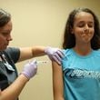 A nurse administers a dose of the HPV vaccine at an Illinois health clinic in 2018. The HPV vaccine, delivered as two or three doses, can significantly cut the risk of infection with HPV, which can cause cancer. (John J. Kim/Chicago Tribune/TNS)