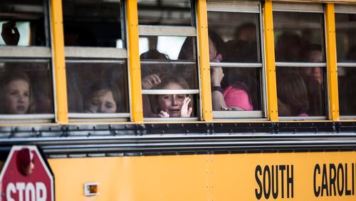 A Townville Elementary student looks out of the window of a school bus as she and her classmates are transported to Oakdale Baptist Church, following a shooting at Townville Elementary in Townville, on Sept. 28, 2016. A teenager killed his father at his home Wednesday before going to the nearby elementary school and opening fire with a handgun, wounding two students and a teacher, authorities said.