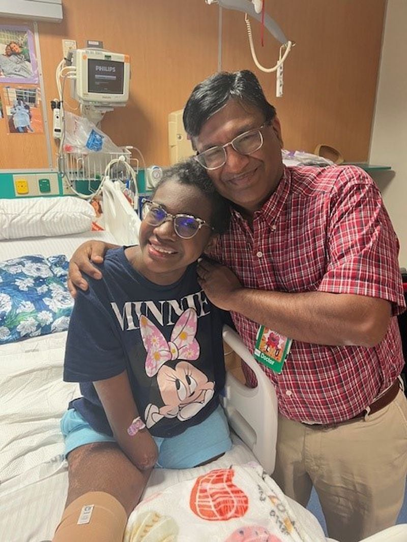 Natalya Manhertz smiles with pediatric anesthesiologist Dr. Vipin Bansal, who alleviated her phantom leg pains post amputation with a ground-breaking nerve stimulator. Courtesy of Manhertz family