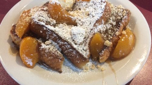 The peach cobbler French toast at Atlanta Breakfast Club is made with two of Georgia's most famous ingredients: peaches are cooked in a brown-butter sauce with a shot of Coca-Cola. PHOTO CREDIT: Wendell Brock