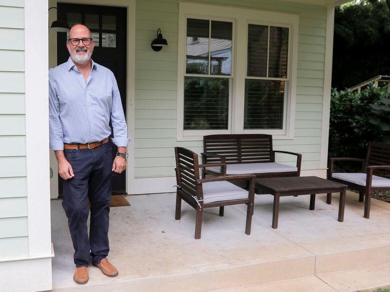 Dirk Brown poses outside the accessory dwelling unit he built in the backyard of his home in Virginia-Highland. (Christine Tannous / christine.tannous@ajc.com)
