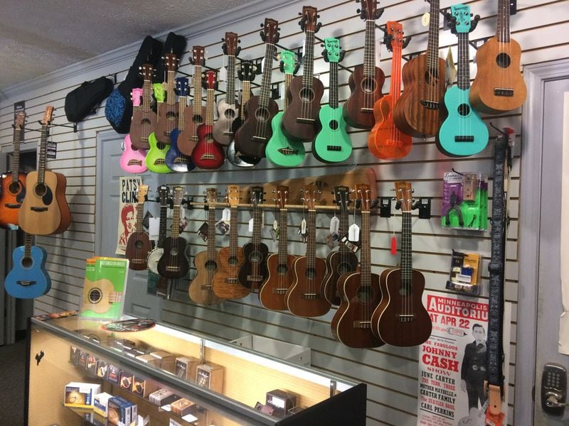 A wall of ukuleles line a portion of Town Center Music in Suwanee. The shop sells all types of instruments and musical accessories, does repairs, provides lessons — and sometimes even provides tuneups for professional musicians before a performance in nearby Town Center Park. JILL VEJNOSKA / JVEJNOSKA@AJC.COM