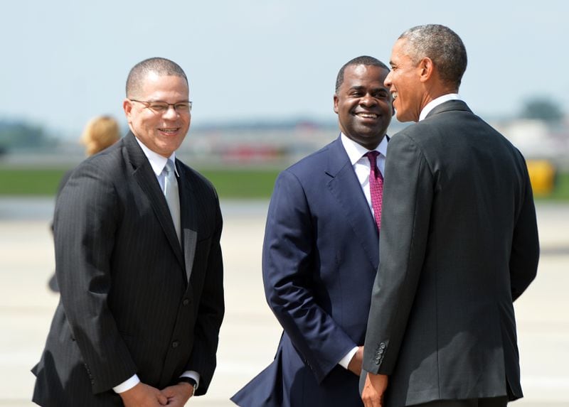 President Barack Obama is greeted by Atlanta Mayor Kasim Reed and Fulton County Chairman John Eaves (left) at Hartsfield Jackson Airport upon his arrival to visit the Centers for Disease Control and Prevention to receive a briefing on the outbreak of the Ebola virus in West Africa in 2014. Reed called Obama and mentor and big brother. HYOSUB SHIN / HSHIN@AJC.COM