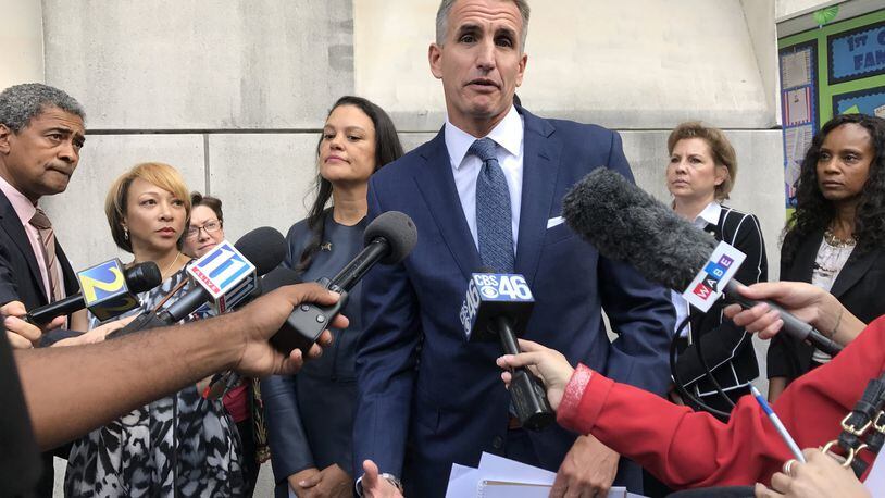 Fulton County Schools Superintendent Jeff Rose, center, and Atlanta Public Schools Superintendent Meria Carstarphen, left, talk to reporters outside Superior Court of Fulton County on Nov. 3, after a judge ordered a temporary tax collection in Fulton County. AJC FILE PHOTO