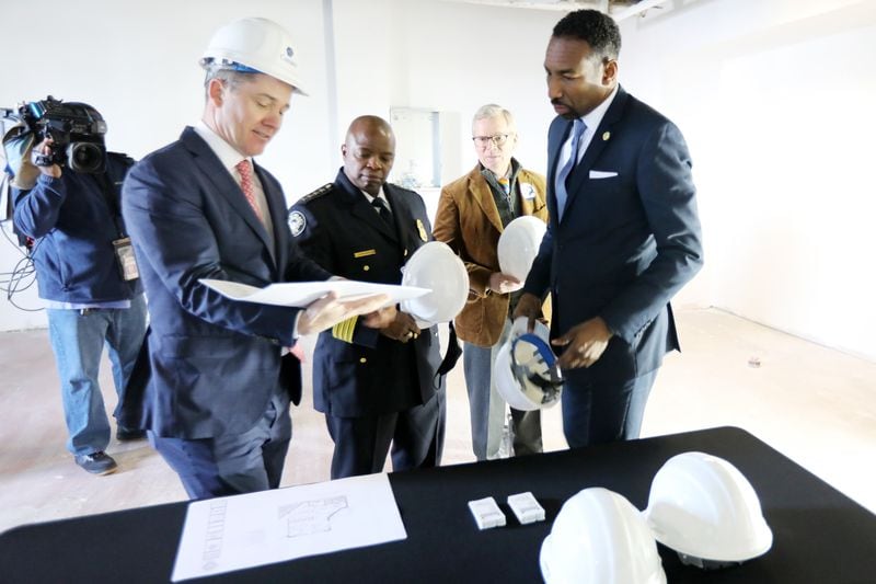 Colin Connolly, CEO of Cousins properties, shows a project plan to Atlanta Mayor Andre Dickens and Chief Police Rodney Bryant the plans for the new Buckhead mini-precinct. Thursday, January 13, 2022 Miguel Martinez for The Atlanta Journal-Constitution 