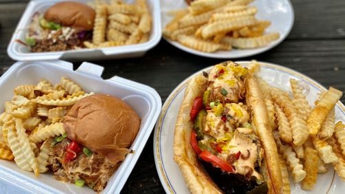 Grass VBQ joint serves wonderful vegan fare, like a smoked brat sandwich made with Beyond Meat sausage (left); a po’boy created from blue oyster mushrooms (right); a vegan, chopped  “veef” brisket sandwich (left rear) and a Nashville hot chic’n sandwich (right rear). 
Wendell Brock for The Atlanta Journal-Constitution