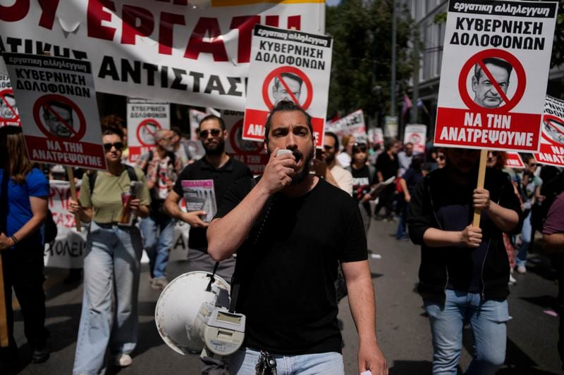 A protester using a loudspeaker shouts slogans during a rally in Athens, Greece, Wednesday, April 17, 2024. A 24-hour strike called by Greece's largest labor union have halted ferries and public transport services in the Greek capital and other cities, to press for a return of collective bargaining rights axed more than a decade ago during a severe financial crisis. (AP Photo/Thanassis Stavrakis)