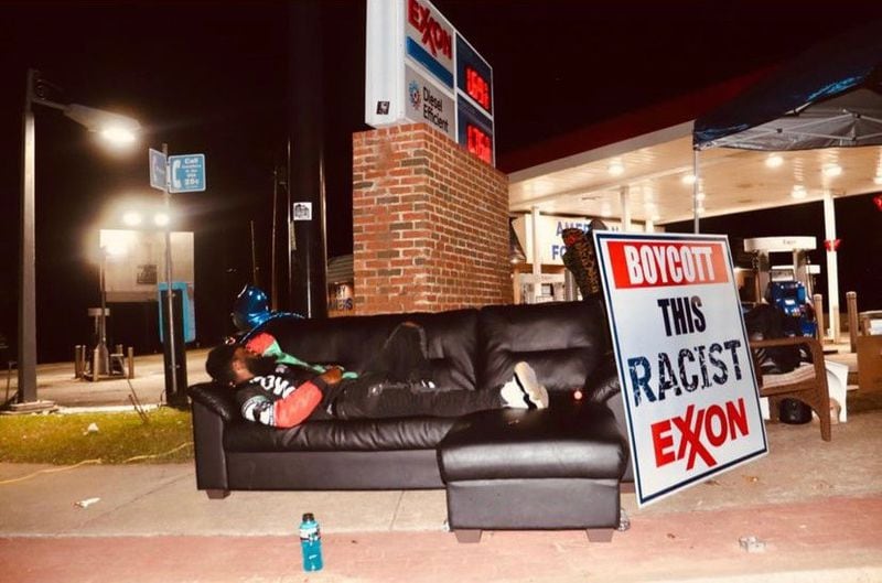 Brian Page, the organizer of a 66-day protest outside the Exxon station at 2345 Flat Shoals Road in DeKalb County, lies on a couch following a night of action in October 2020. SPECIAL PHOTO/ZACKERY WEAVER