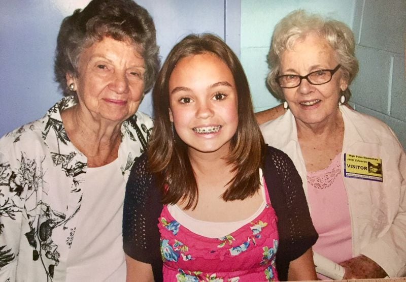 Grace and her great-grandmothers, Julia Donaldson (left), and Janet Edwards, at her fifth-grade graduation in 2012. After Johnny and Grace moved to Atlanta, they took turns greeting Grace at her house when she got off the bus. Contributed