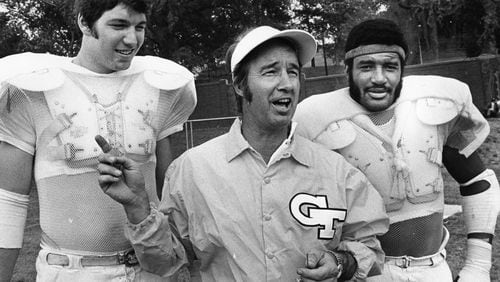 Georgia Tech coach Pepper Rodgers (middle) stands with players Billy Shields (left) and Joe Harris (right) at practice in 1974. (Billy Downs / AJC)