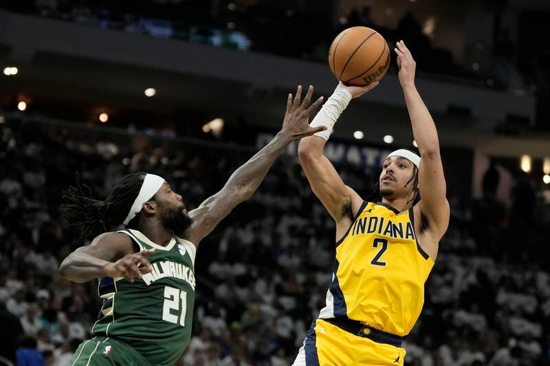 Indiana Pacers' Andrew Nembhard shoots over Milwaukee Bucks' Patrick Beverley during the second half of Game 2 of the first round NBA playoff basketball series Tuesday, April 23, 2024, in Milwaukee.The Pacers won 125-108 to tie the series 1-1. (AP Photo/Morry Gash)
