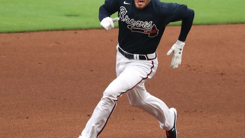 071820 Atlanta: Atlanta Braves first baseman Freddie Freeman rounds second base hitting a triple during the second inning in his first game back since testing positive with COVID-19 in an intrasquad game on Saturday, July 18, 2020 in Atlanta.   Curtis Compton ccompton@ajc.com