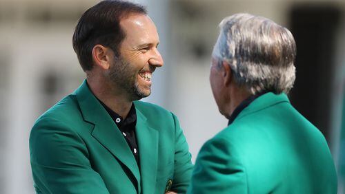 Defending Masters champion Sergio Garcia shares a laugh with 3-time champion Gary Player outside the clubhouse at Augusta National Golf Club on Sunday, April 1, 2018, in Augusta.  Curtis Compton/ccompton@ajc.com