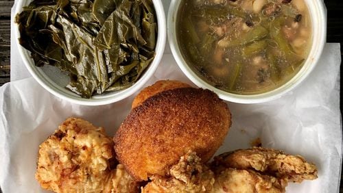 This takeout plate from Bare Bones Steakhouse includes collards, black-eyed peas, fried chicken and a corn muffin. CONTRIBUTED BY WENDELL BROCK