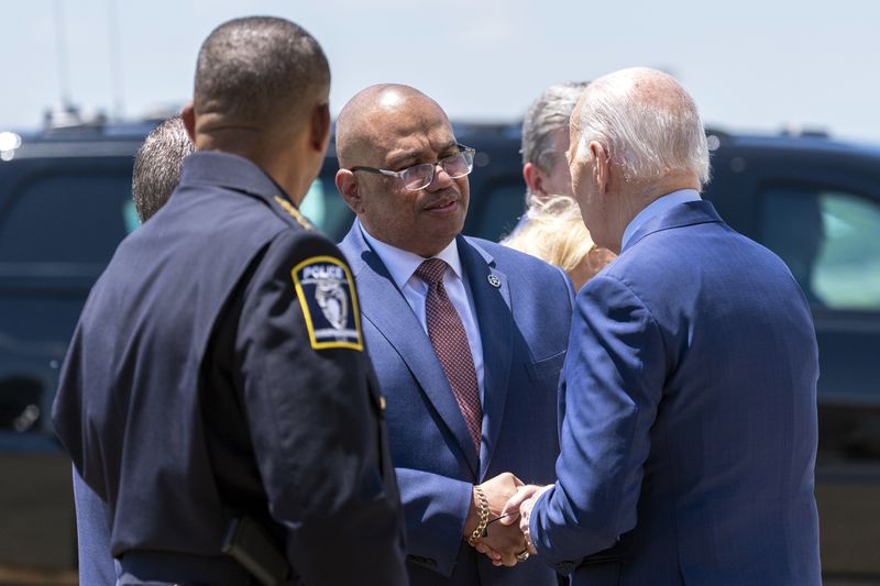 U.S. Marshals Service Director Ronald Davis, center, speaks with President Joe Biden, as he arrives on Air Force One at Charlotte Douglas International Airport, Thursday, May 2, 2024, in Charlotte, N.C. Biden is meeting with the families of law enforcement officers shot to death on the job. (AP Photo/Alex Brandon)