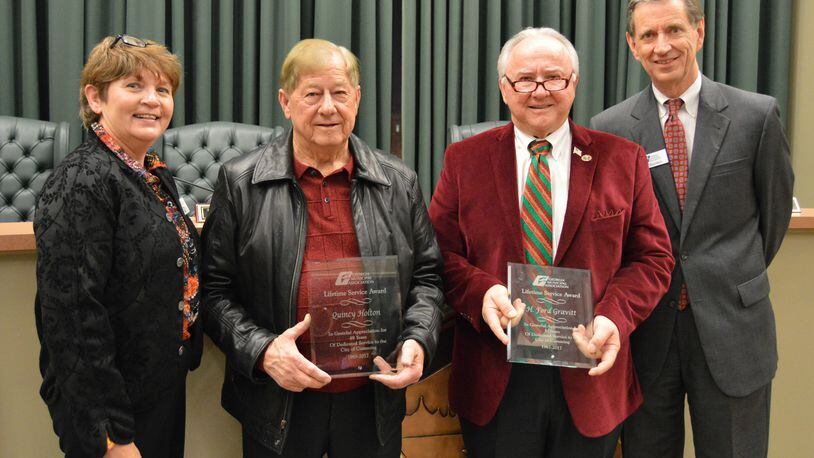 Cumming mayor H. Ford Gravitt, center right, and council member Quincy Holton, center left,were honored with lifetime achievement awards from the Georgia Municipal Association.