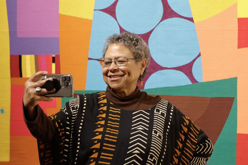 Photographer Susan “Sue” Ross takes a selfie during the VIP reception for the museum’s latest exhibition “Threaded” on Thursday, Feb. 1, 2024. (Natrice Miller/ Natrice.miller@ajc.com)