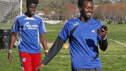 Saadiq Mohammed, left, and Sa'ad Hussein check their sprint times in Forest Park on April 7, 2016, in St. Louis during a soccer practice as they try to get back into shape so they can compete on teams in St. Louis. (J.B. Forbes/St. Louis Post-Dispatch/TNS)