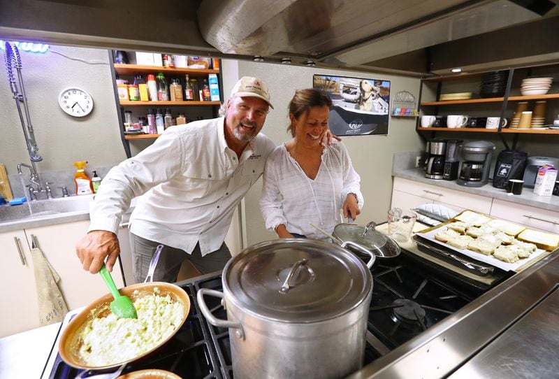 Steve Bartkowski clowns around with his wife Sandee while they prepare breakfast for guests at Ruby Drake Lodge. (Curtis Compton/ccompton@ajc.com)