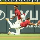 Lowndes outfielders Jordan Hudson, center diving, and Qrey Lott cannot make the catch on a ball hit by Parkview’s Makhi Buckley (not pictured) during the sixth inning in game one of the GHSA baseball 7A state championship at Truist Park, Tuesday, May 16, 2023, in Atlanta. It was determined Buckley was out at third base and the scoring run on the play did not count. Lowndes won 3-2. (Jason Getz / Jason.Getz@ajc.com)