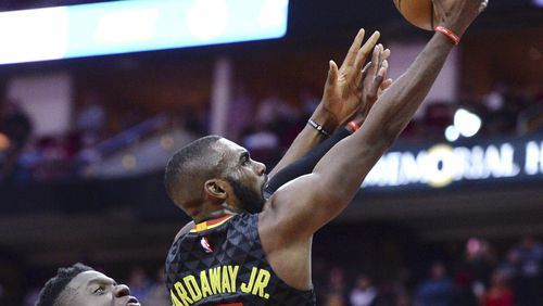 Atlanta Hawks guard Tim Hardaway Jr. (10) scores in front of Houston Rockets center Clint Capela during the second half of an NBA basketball game Thursday, Feb. 2, 2017, in Houston. (AP Photo/George Bridges)