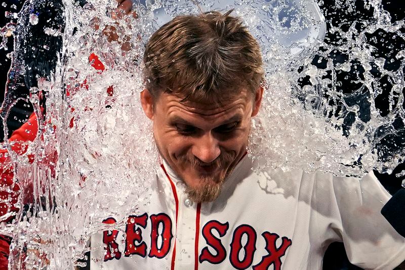 Boston Red Sox pitcher Tanner Houck is doused after he threw a three-hitter against the Cleveland Guardians in a baseball game Wednesday, April 17, 2024, in Boston. The Red Sox won 2-0. (AP Photo/Charles Krupa)