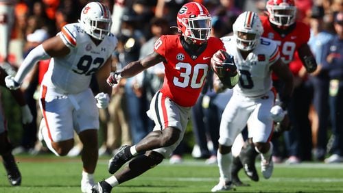 Georgia running back Daijun Edwards makes a long 20-plus yard run for a first down against Auburn during the first quarter Saturday, Oct. 8, 2022, in Athens.  Curtis Compton / AJC file