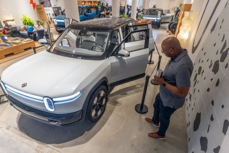  Rivian employee Russ Mooney looks over the new R2 prototype that will eventually be made in Georgia.