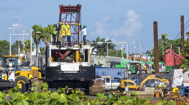Bingham Island is filled with construction equipment as work progresses on the $93 million replacement of the Southern Boulevard Bridges over the Intracoastal Waterway and Lake Worth Lagoon on June 26, 2017. A temporary bridge is being built north of the existing bridge before construction on the new drawbridge begins. The project is due to be completed in late 2020. (Lannis Waters / The Palm Beach Post)
