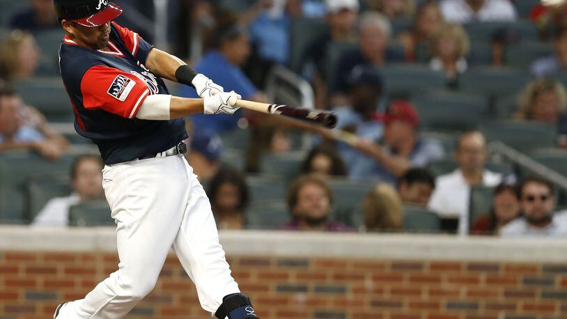 ATLANTA, GA - AUGUST 25:  Catcher Kurt Suzuki #24 of the Atlanta Braves hits a home run in the second inning during the game against the Colorado Rockies at SunTrust Park on August 25, 2017 in Atlanta, Georgia.  (Photo by Mike Zarrilli/Getty Images)
