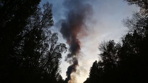 A plume of smoke rises from the site of an explosion on the Colonial Pipeline on Monday, Oct. 31, 2016, in Helena, Ala. (AP Photo/Brynn Anderson)