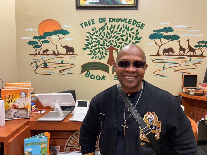 Henry Carter, the owner of Tree of Knowledge Bookstore, posed for a picture inside his shop at the New Black Wall Street Market on Oct. 15, 2022.