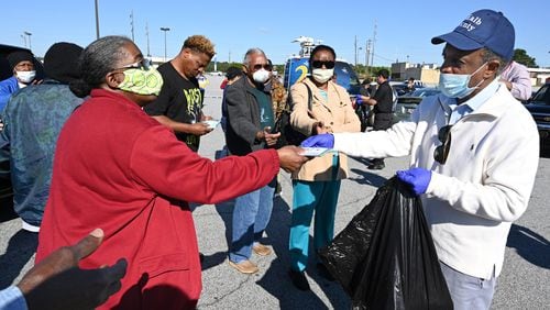 DeKalb County CEO Michael Thurmond hands COVID-19 care kits out to residents at Big Lots parking lot on Candler Road in Decatur on Saturday, May 9, 2020. (Photo: Hyosub Shin / Hyosub.Shin@ajc.com)