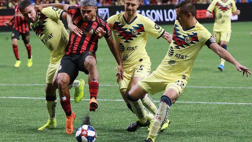 August 14, 2019 Atlanta: Atlanta United forward Josef Martinez battles Club America defenders Bruno Valdez (from left), Guido Rodriguez, and Antonio Lopez in front of the goal in the Campeones Cup on Wednesday, August 14, 2019, in Atlanta.   Curtis Compton/ccompton@ajc.com