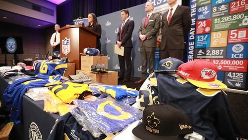 Fake NFL merchandise covers a table as the National Football League and law enforcement agencies announce the latest results of seizures of counterfeit game-related merchandise and tickets during a press conference at the Georgia World Congress Center on Thursday, Jan. 31, 2019, in Atlanta. Curtis Compton/ccompton@ajc.com