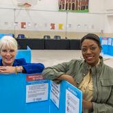 Nina Altschiller, left, and Chassidy Malloy, right, of the League of Women Voters of Coastal Georgia, pose at the Chatham County Voter Registration auxiliary office Wednesday, April 17, 2024, in Savannah, Ga. (Stephen B. Morton for The Atlanta Journal-Constitution)