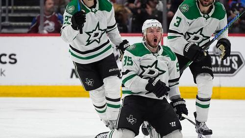 Dallas Stars center Matt Duchene, front, celebrates after scoring the winning goal as defensemen Esa Lindell, back left, and Chris Tanev look on in the second overtime of Game 6 of an NHL hockey playoff series Friday, May 17, 2024, in Denver. (AP Photo/David Zalubowski)