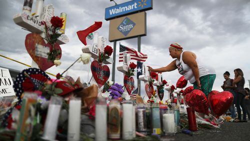 EL PASO, TEXAS - AUGUST 06:  A woman touches a cross at a makeshift memorial for victims outside Walmart, near the scene of a mass shooting which left at least 22 people dead, on August 6, 2019 in El Paso, Texas. A 21-year-old white male suspect remains in custody in El Paso, which sits along the U.S.-Mexico border. President Donald Trump plans to visit the city August 7. (Photo by Mario Tama/Getty Images) ***BETSPIX***