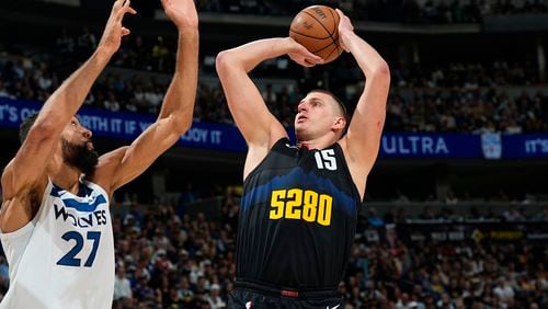 Denver Nuggets center Nikola Jokic shoots over Minnesota Timberwolves center Rudy Gobert during the first half of Game 5 of an NBA basketball second-round playoff series Tuesday, May 14, 2024, in Denver (AP Photo/David Zalubowski)