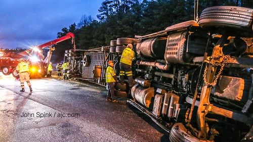 A tractor-trailer hauling 41,000 pounds of cheese overturned on Ga. 20 in Gwinnett County early Monday. The driver is accused of driving too fast for conditions.
