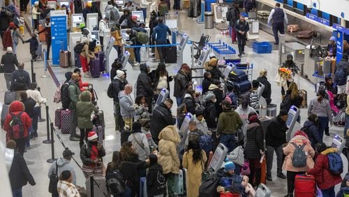 Early morning travelers check in before their flights at Hartsfield-Jackson International Airport Saturday, Dec. 24, 2022. (Photo: Steve Schaefer / steve.schaefer@ajc.com)