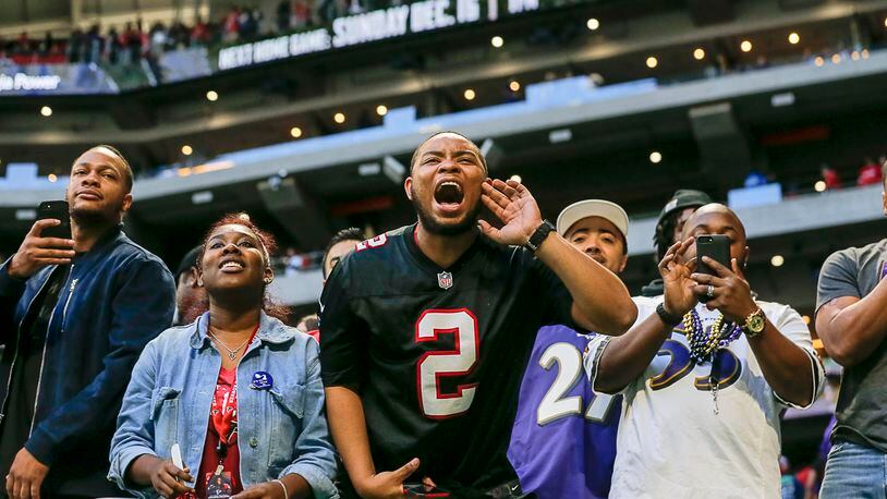 Falcons fans watch the team leave the field following a loss to the Baltimore Ravens at Mercedes-Benz Stadium on Dec. 2.