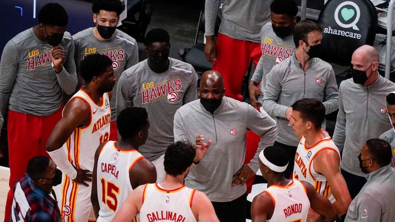 Atlanta Hawks interim coach Nate McMillan (center) talks in a huddle with the team during the first half against the Sacramento Kings on Saturday, March 13, 2021, at State Farm Arena in Atlanta. (Brynn Anderson/AP)