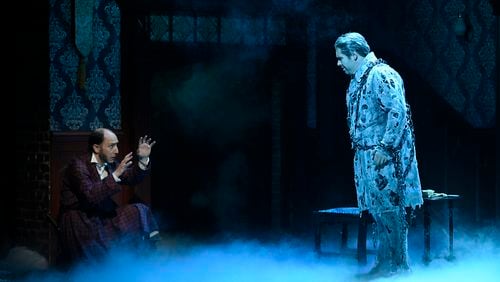 Ebenezer Scrooge (Andrew Benator) cowers when confronted by the ghost of Jacob Marley (Matthew Morris) in Alliance Theatre's 2022 production of "A Christmas Carol." Photo: Courtesy of the Alliance Theatre / Greg Mooney