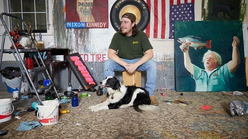 Painter Evan Jones sits with his dog Ace in his Austell studio.
(Courtesy of Maddy Michelle)
